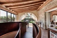 a dining room with wooden ceilings and chairs at Locanda dell'Aioncino in Bibbona