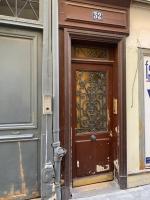 a brown door with a sign on it at 15 Atelier Montorgueil Super Héros in Paris