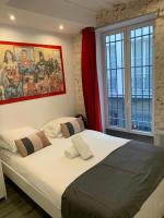 a bedroom with a large bed in front of a window at 15 Atelier Montorgueil Super Héros in Paris