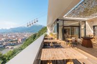 a balcony of a building with tables and chairs at Les Appartements de Grenoble in Grenoble