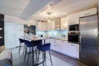 a kitchen with white cabinets and a stainless steel refrigerator at Magnifique Appart Stade de France gare Terasse Paris 6 pers in Saint-Denis