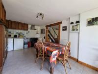 a kitchen with a table and chairs in a room at Gîte de charme - Normandie in Breteuil-sur-Iton