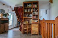 a room with a desk and a book shelf with books at Gîte de charme - Normandie in Breteuil-sur-Iton