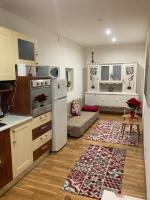 a kitchen and living room with a couch and a table at Casa Mia in Bari
