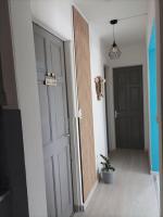 an empty hallway with a door and a potted plant at Villa Imelda à saint André la réunion in Le Patelin