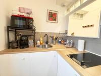 a kitchen counter with a sink and a microwave at AuKabest 3 * Proche ferry * Gare in Calais