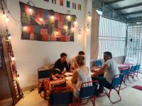 a group of people sitting around a table at Ha Giang Yolo House and Loop Tours in Ha Giang