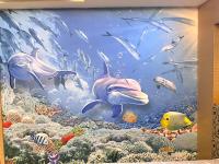 a mural of the ocean with dolphins and fish at JinShan Sakura Bay Hot Spring Hotel in Jinshan