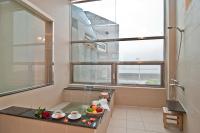 a bathroom with a shower with a bowl of fruit on a counter at JinShan Sakura Bay Hot Spring Hotel in Jinshan