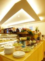 a buffet line in a restaurant with plates of food at JinShan Sakura Bay Hot Spring Hotel in Jinshan
