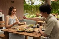 a man and a woman sitting at a table eating food at Tantawan Tented Camp in Ban San Khong