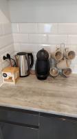 a kitchen counter with a coffee maker and pots and pans at T2 de 42m² A proximité de la gare à 30min de PARIS in Mantes-la-Jolie