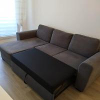 a brown couch sitting in a living room at T2 de 42m² A proximité de la gare à 30min de PARIS in Mantes-la-Jolie