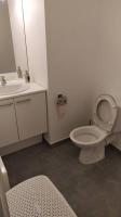 a bathroom with a white toilet and a sink at T2 de 42m² A proximité de la gare à 30min de PARIS in Mantes-la-Jolie