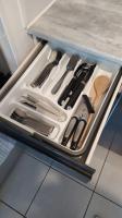 a drawer in a refrigerator filled with utensils at T2 de 42m² A proximité de la gare à 30min de PARIS in Mantes-la-Jolie
