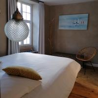 a bedroom with a large white bed and a window at L Appart des Cloutiers in La Rochelle