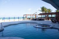 ein Pool neben einem Strand mit dem Meer in der Unterkunft New Casablanca Praia Hotel in Paulista