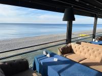 a room with a couch and a table on the beach at KENT hotel & Restaurant KENT beach in K'obulet'i