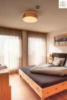Łóżko lub łóżka w pokoju w obiekcie Haus Percha Mountain Apartments