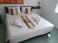a white bed with towels and bows on it at Samui Green Hotel in Chaweng