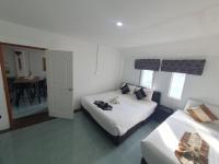a hotel room with two beds and a table at Samui Green Hotel in Chaweng