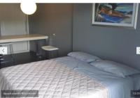 A bed or beds in a room at Uniclub House