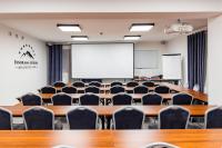 an empty classroom with tables and chairs at Panorama Górska Wisła Resort & SPA in Wisła