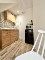 a kitchen with a black refrigerator and a microwave at Logement Entier au Centre Ville in Évreux