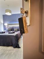 a room with two beds and a tag on a door at &#39;&#39;Les Platanes&#39;&#39;de Miss.K Conciergerie in Gorrevod