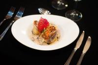 a white plate of food with a strawberry on it at Colores de Purmamarca in Purmamarca