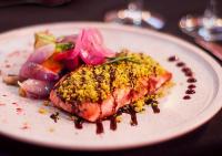 a plate of food with a piece of fish and vegetables at Colores de Purmamarca in Purmamarca