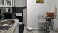 a small kitchen with a sink and a table at Studio in Aurillac