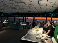 a group of people sitting at tables in a restaurant at KENT hotel & Restaurant KENT beach in K'obulet'i