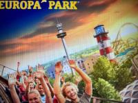 a group of people with their hands in the air in front of a lighthouse at MOBIL HOME Clim BOOFZHEIM 6 PERSONNES 3 CHAMBRES LE RIED 3 ETOILES PROCHE EUROPA PARK in Boofzheim