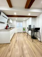 a kitchen with white cabinets and a wooden floor at Strasbourg magnifique appartement centre ville Petite France in Strasbourg