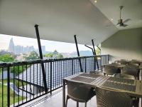 a balcony with chairs and a table with a view at Domitys Bangsar Kuala Lumpur in Kuala Lumpur