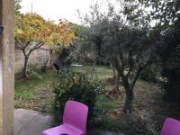 two purple chairs sitting in a garden with trees at FLC-Sea View-Jacuzzi-3 Bedrooms-8p-Parking for 2 cars in Marseille