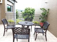 a patio with four chairs and a table and a table and chairs at Bestime B&amp;B in Jiji