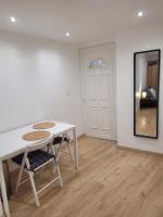 a white table and chairs in a room with a door at Cosy Studio in Saint-Mitre-les-Remparts