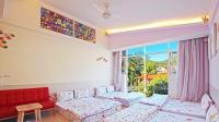 a living room with two beds and a red couch at Wan-Yue B&amp;B in Hengshan