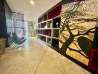 a living room with a tree mural on the wall at LFlats no Hotel Stella Vega (EX-Mercury Ibirapuera) in Sao Paulo