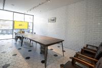a conference room with a wooden table and chairs at CHECK inn Taipei Songjiang in Taipei