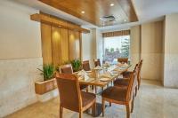a dining room with a long table and chairs at Hotel Crowne Imperial in Kathmandu