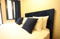 A bed or beds in a room at Asmali Hotel