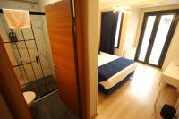 A bed or beds in a room at Asmali Hotel