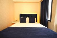 A bed or beds in a room at Asmali Hotel