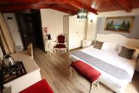 A bed or beds in a room at Asmali Hotel