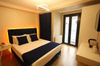 A bed or beds in a room at Asmali Hotel