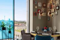 a dining room with a table and a large window at Vienna House by Wyndham Andel's Berlin in Berlin