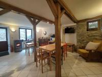 a kitchen and living room with a table and a fireplace at Le Vieux La Roche in La-Roche-en-Ardenne